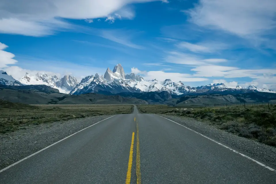 An empty gravel road cutting through the Carretera Austral wilderness