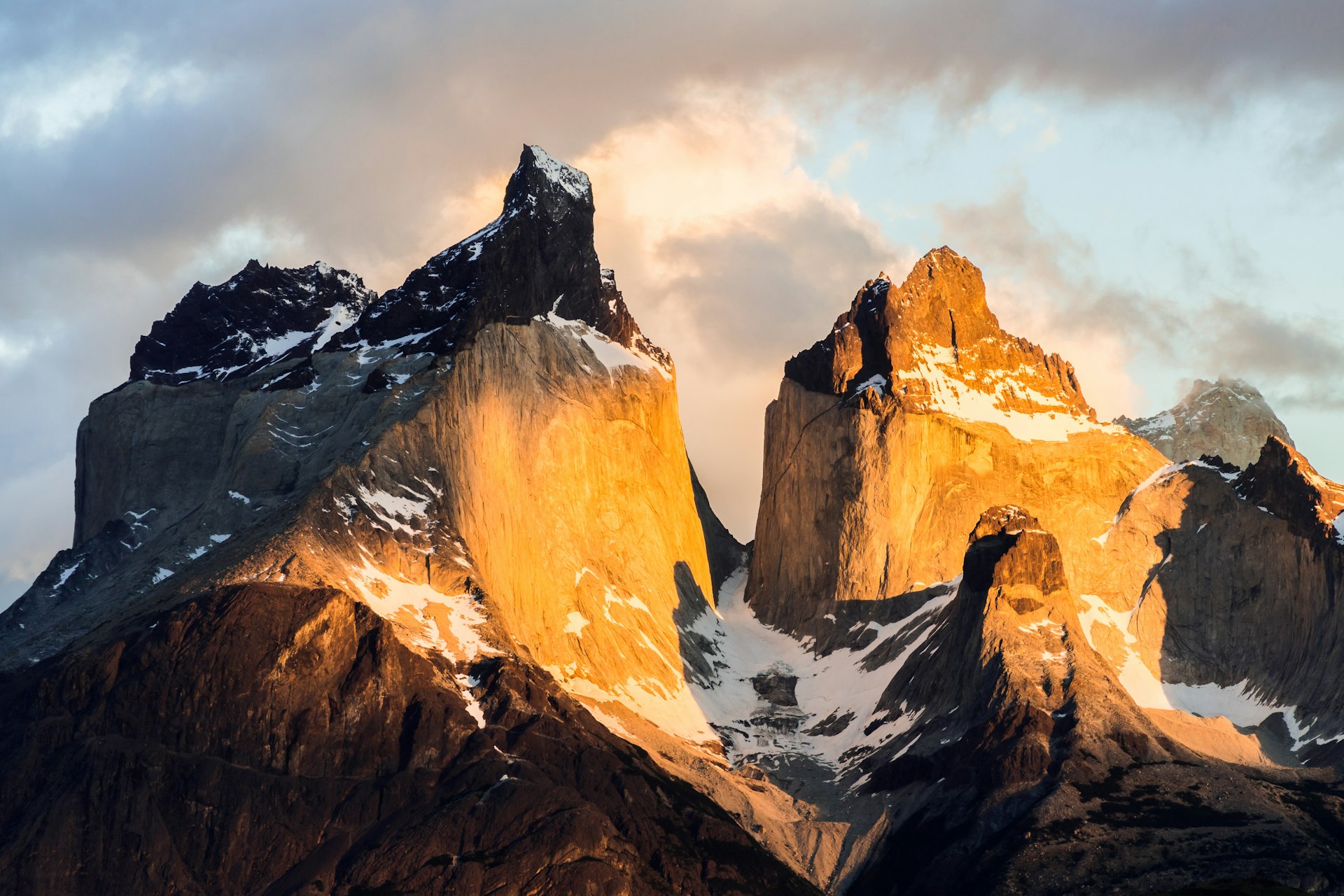 Windswept Patagonian steppe stretching toward jagged peaks at first light