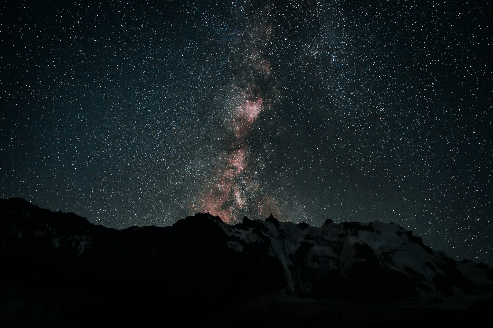 The southern night sky over dark peaks
